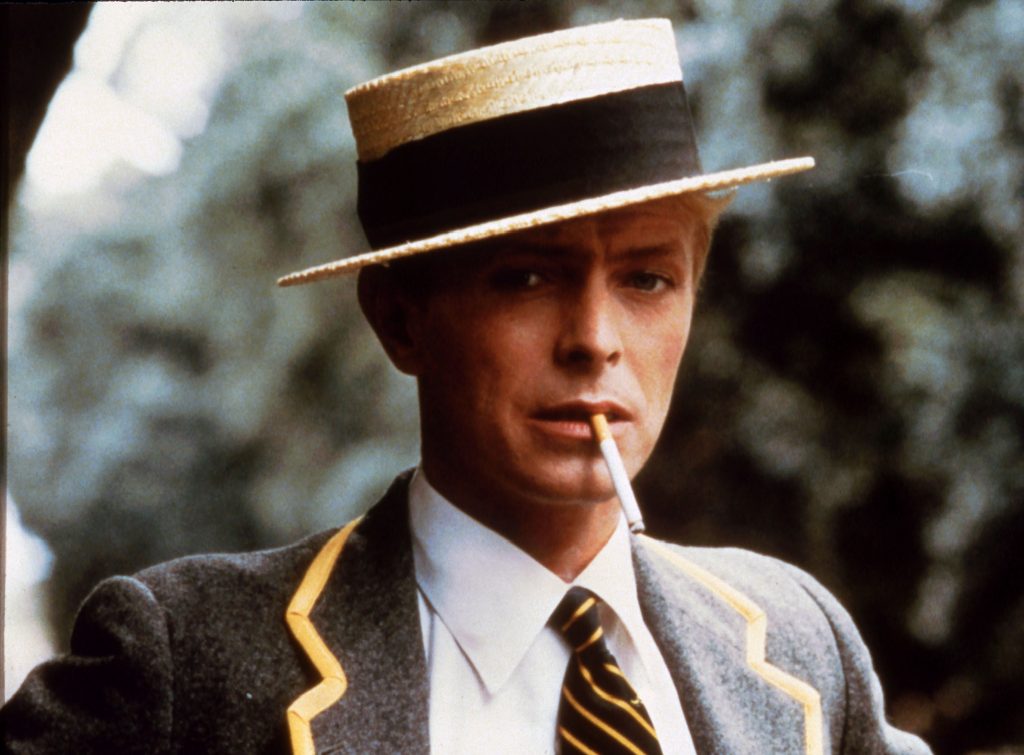 David Bowie in boater hat. Publicity still for Merry Christmas, Mr. Lawrence (1983)